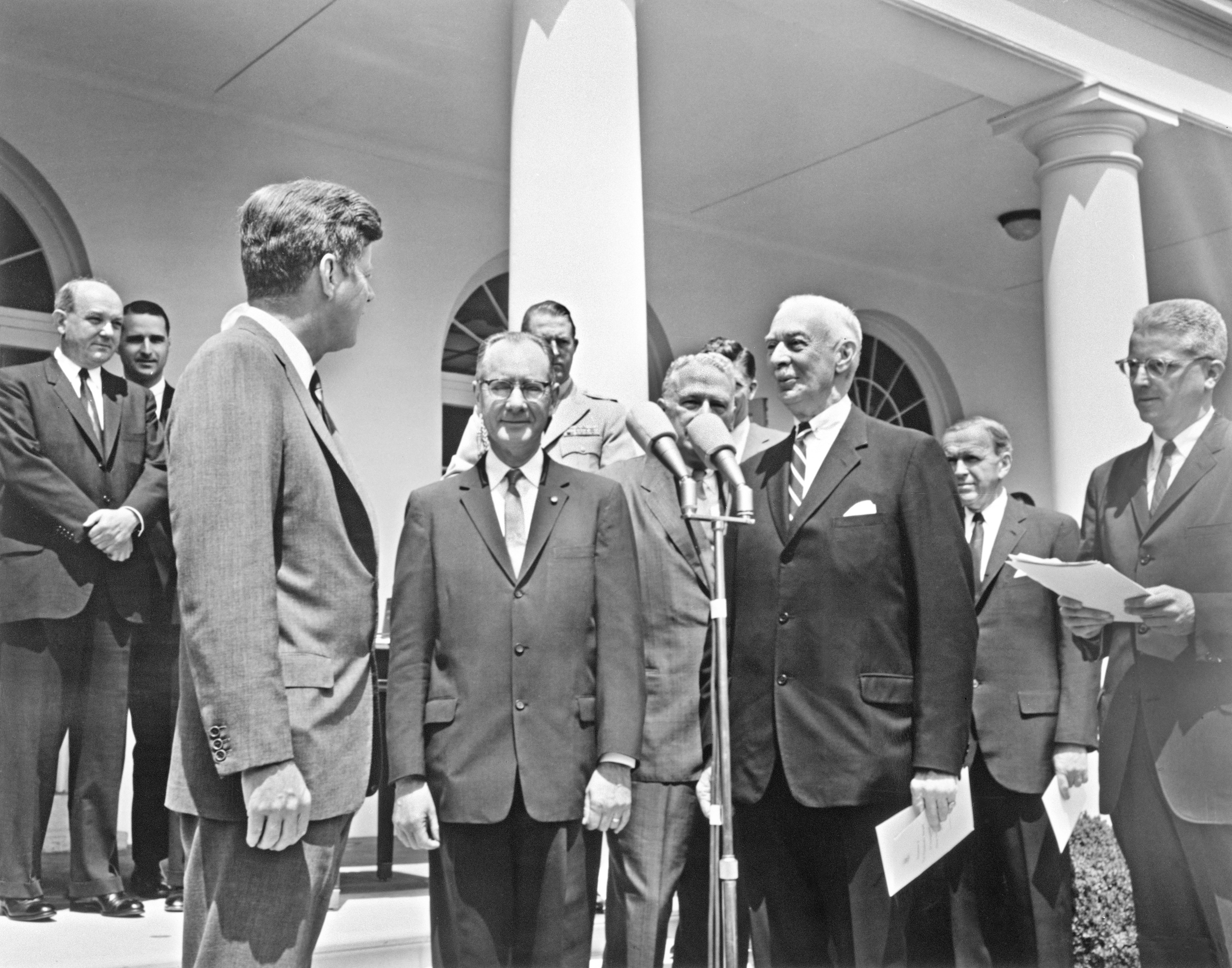 Former SAO Director Fred Lawrence Whipple stands between President John F. Kennedy and Secretary Leonard Carmichael outside the White House in the Rose Garden to recieve the "Distinguished Federal Civilian Award."