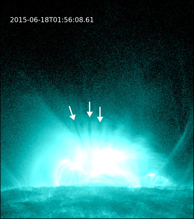 Still image of several supra-arcade downflows, also described as "dark, finger-like features," occurring in a solar flare. The downflows appear directly above the bright flare arcade. This solar flare occurred on June 18, 2015.