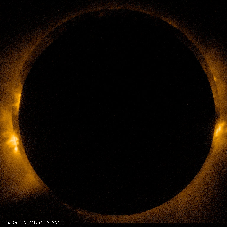 A large dark black empty dot surrounded by the fiery rays of the sun.