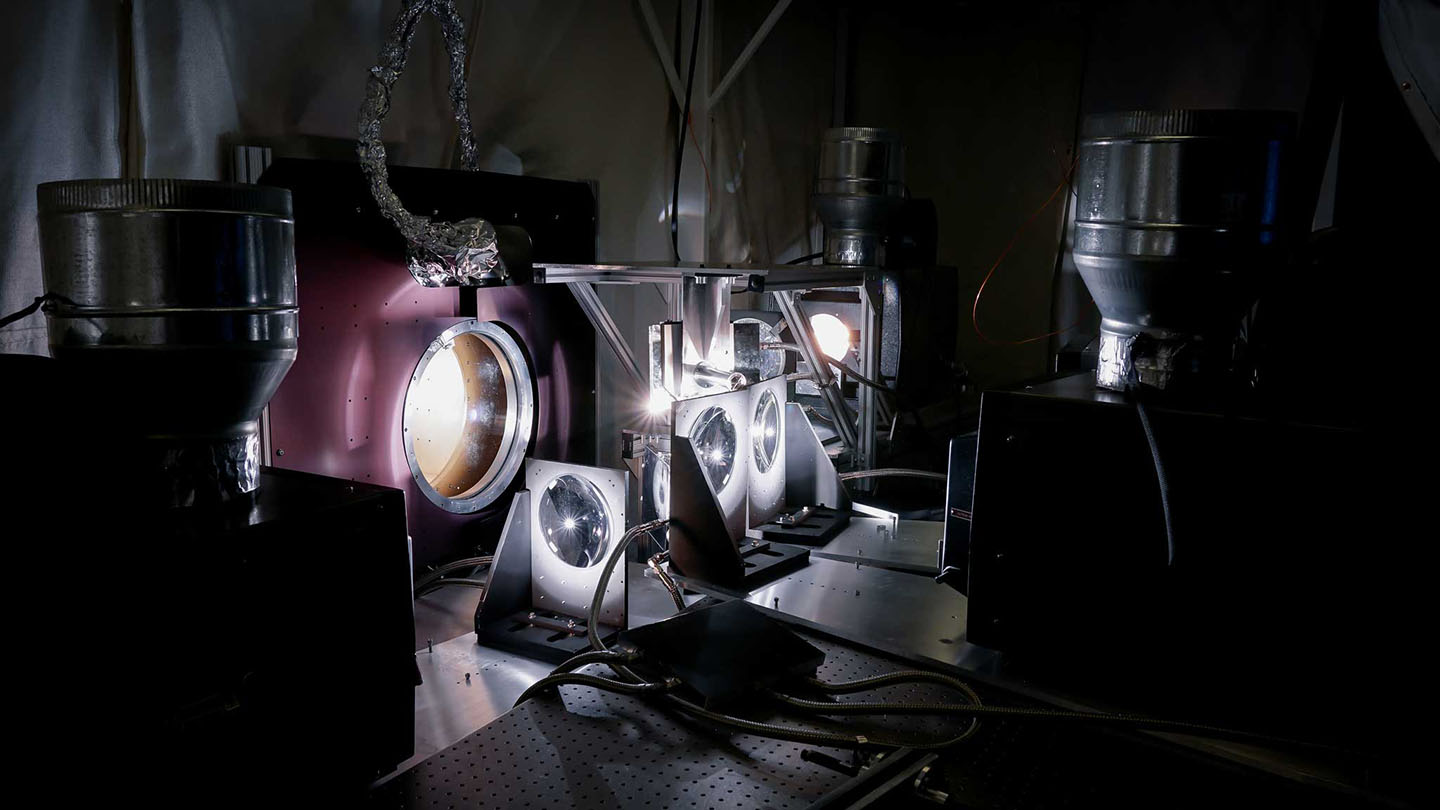 Researchers use a quartet of IMAX projectors to create the light and heat the Parker Solar Probe cup will experience during its trips through the sun&#039;s atmosphere. The cup sits inside a vacuum chambers set up in a lab at the Smithsonian Astrophysical Observatory in Cambridge, Massachusetts.