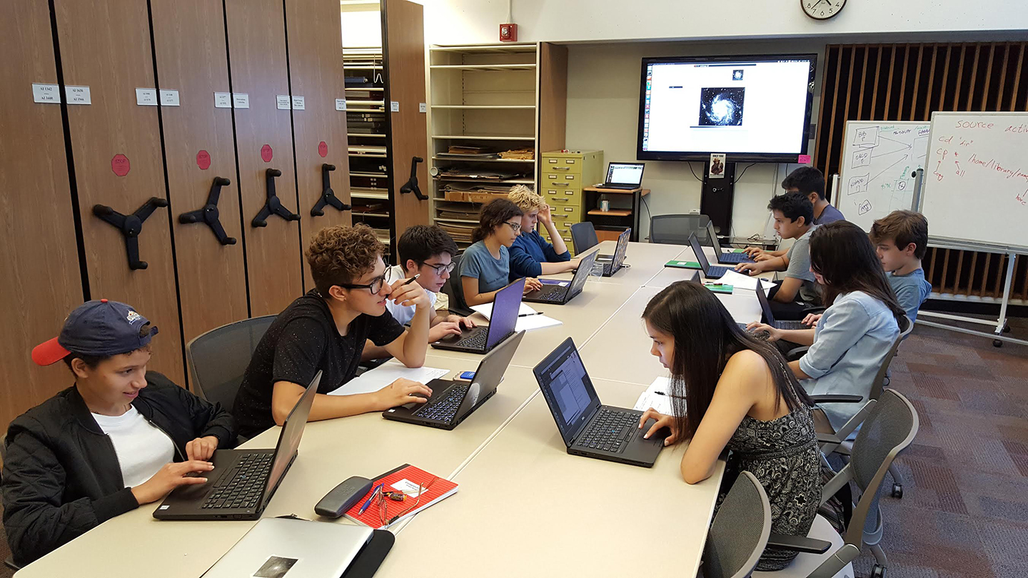 High school students in the first cohort of the Science Research Mentoring Program learn how to work with astronomical images in the Harvard-Smithsonian Center for Astrophysic&#039;s Wolbach Library.