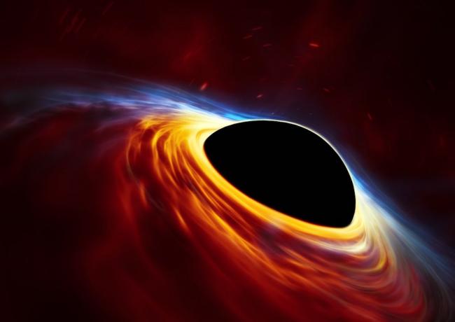 artist's impression of a spinning black hole surrounded by an accretion disc.