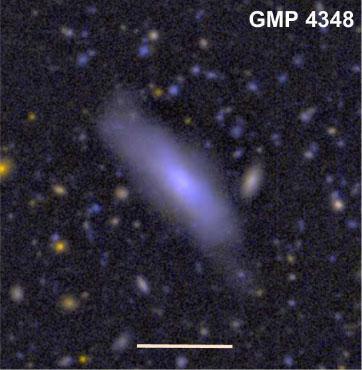An optical image of the ultra-diffuse galaxy GMP 4348 in the Coma cluster of galaxies; the scale bar shows a distance of thirty-two thousand light-years.