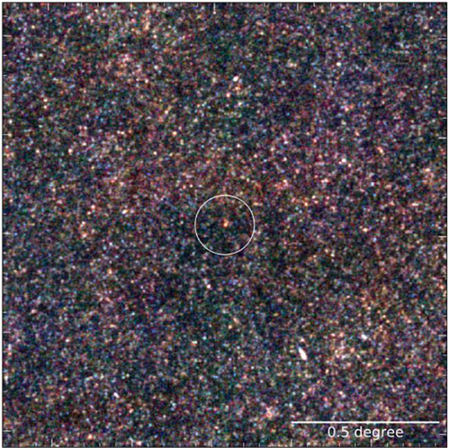A false-color image of the far-infrared emission from a massive protocluster of galaxies (in the circle) dating from the epoch about 1.4 billion years after the big bang.