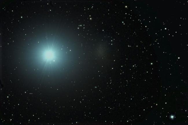 The ultra-faint Milky Way companion galaxy Leo I appears as a faint patch to the right of the bright star, Regulus. 